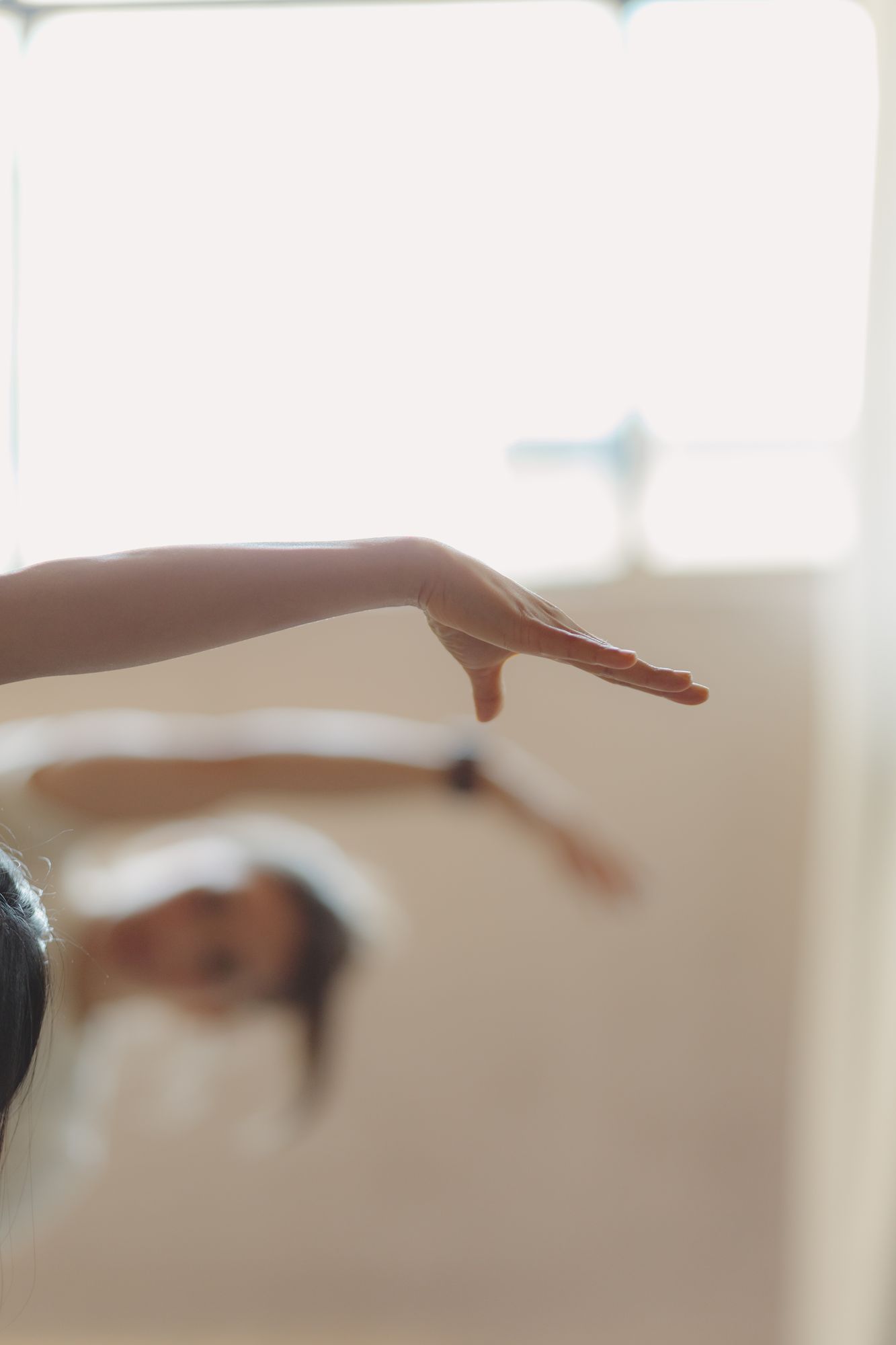 A client extending an arm during a reformer class at Leaside Pilates